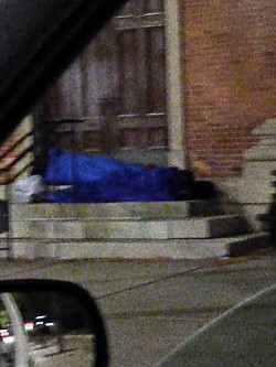 A Dear Homeless Person sleeping on stairs in the Streets